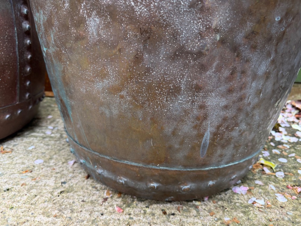 A matched pair of 19th-century copper wash tubs with riveted seams, wide rolled rims, and natural verdigris oxidisation. View VIII
