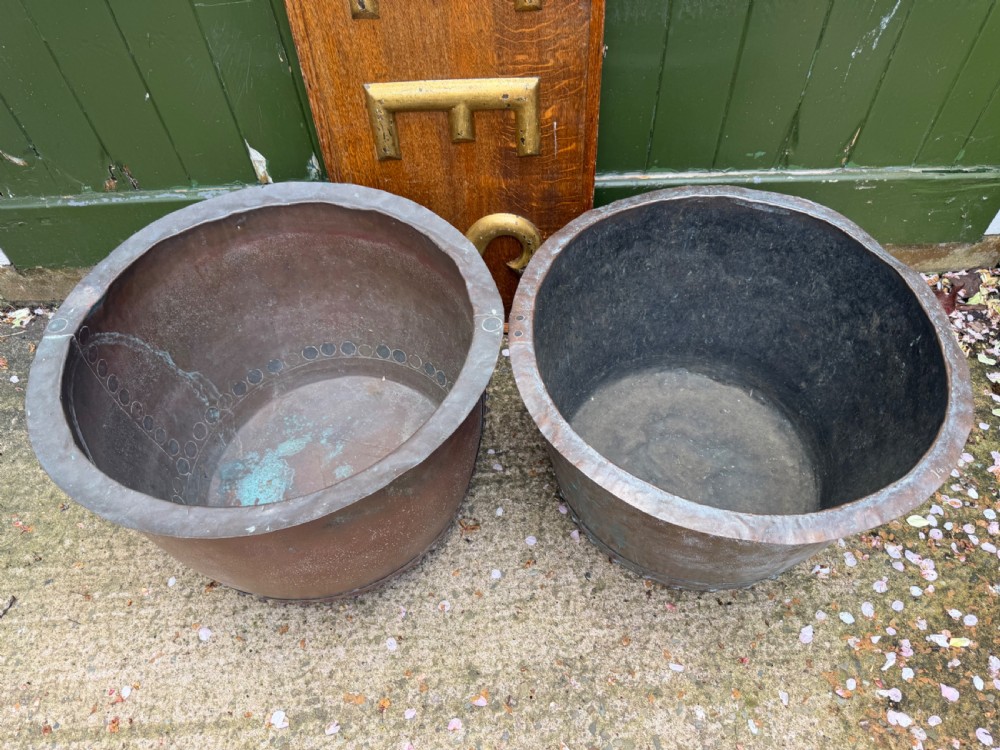 A matched pair of 19th-century copper wash tubs with riveted seams, wide rolled rims, and natural verdigris oxidisation. View IX