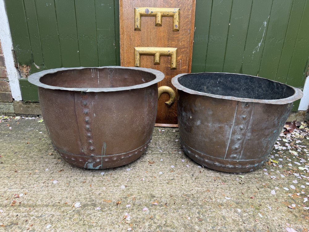 A matched pair of 19th-century copper wash tubs with riveted seams, wide rolled rims, and natural verdigris oxidisation. View XX
