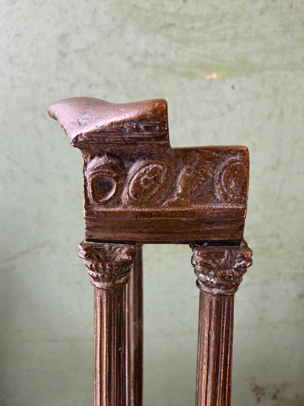 A set of three late 19th-century miniature polished bronze models representing ancient Roman temple ruins mounted on green marble bases. View IX