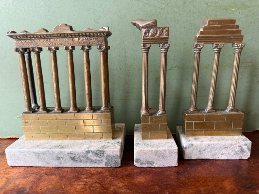 A set of three late 19th-century miniature polished bronze models representing ancient Roman temple ruins mounted on green marble bases. View XI
