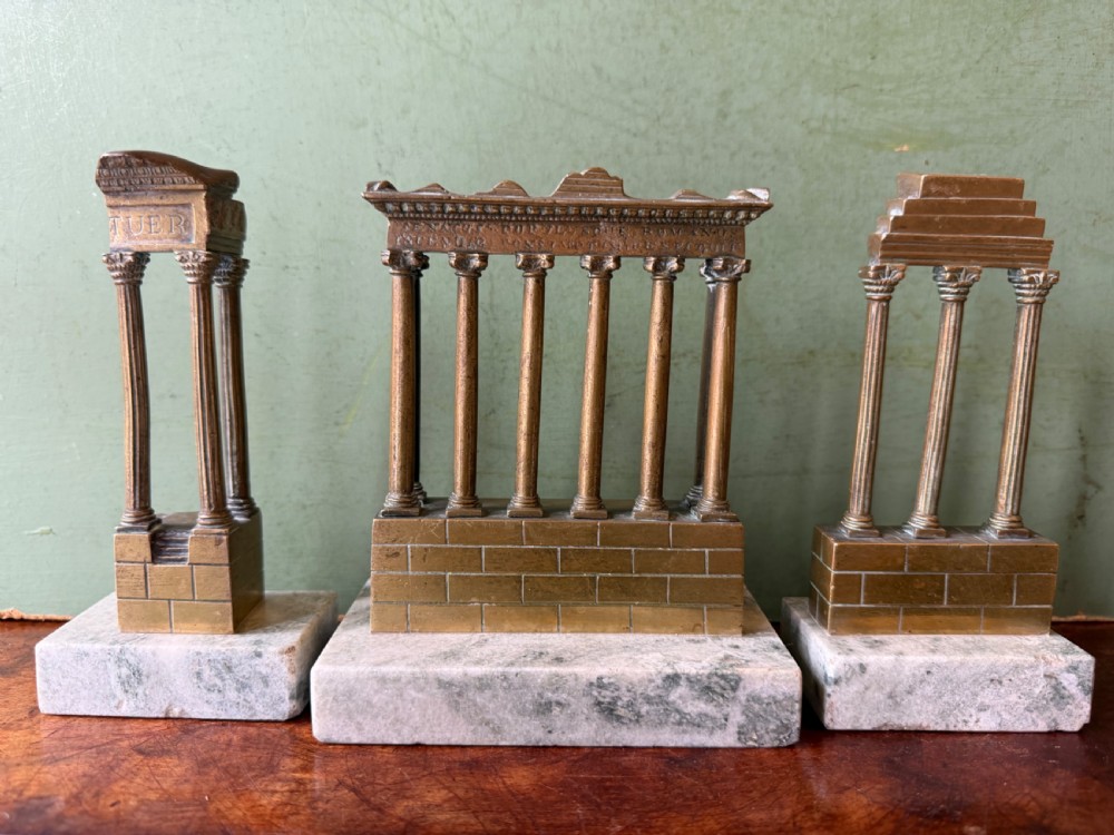 A set of three late 19th-century miniature polished bronze models representing ancient Roman temple ruins mounted on green marble bases. View XIV