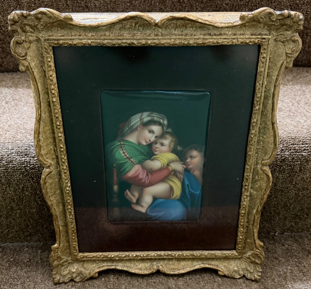 A late nineteenth-century hand-painted rectangular porcelain plaque depicting the Madonna and Child set within a velvet mount and an ornate swept gilt frame. View III