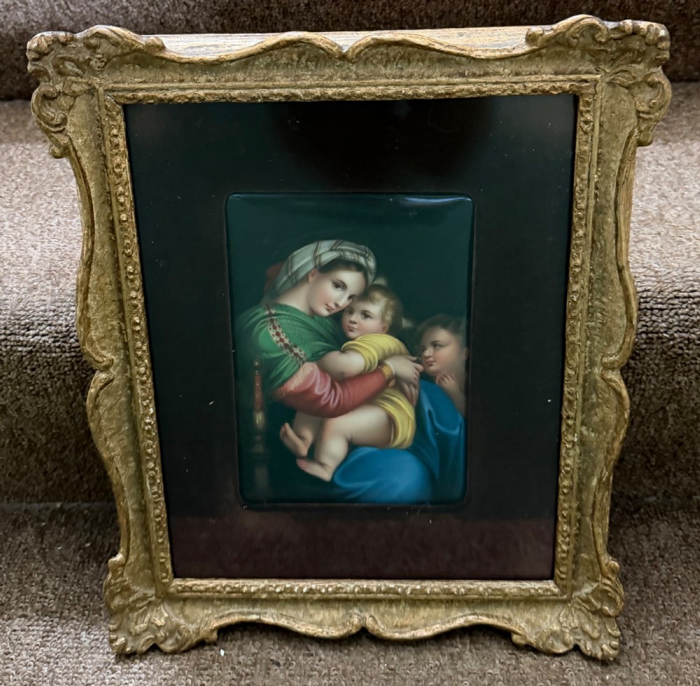 A late nineteenth-century hand-painted rectangular porcelain plaque depicting the Madonna and Child set within a velvet mount and an ornate swept gilt frame. View IV