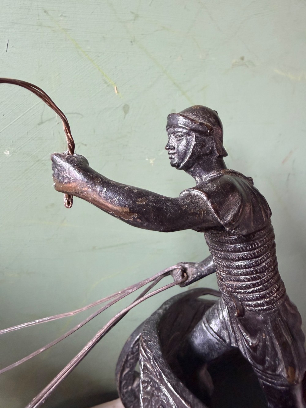 A mid-19th-century dark bronze sculpture depicting a Roman charioteer driving two rearing horses, mounted on a rectangular white marble plinth. View V