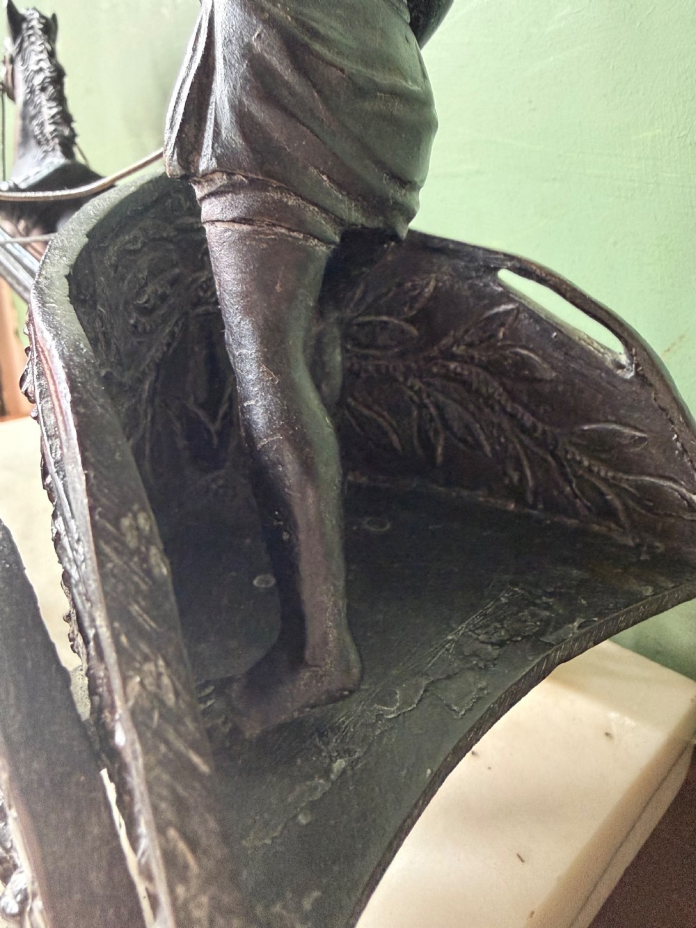 A mid-19th-century dark bronze sculpture depicting a Roman charioteer driving two rearing horses, mounted on a rectangular white marble plinth. View VI