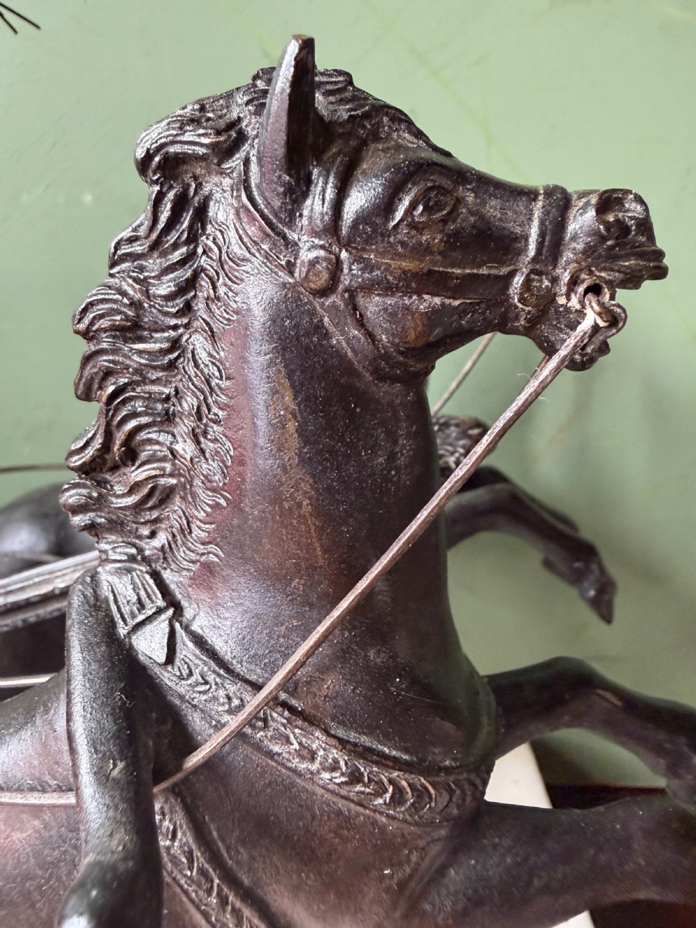 A mid-19th-century dark bronze sculpture depicting a Roman charioteer driving two rearing horses, mounted on a rectangular white marble plinth. View XIII