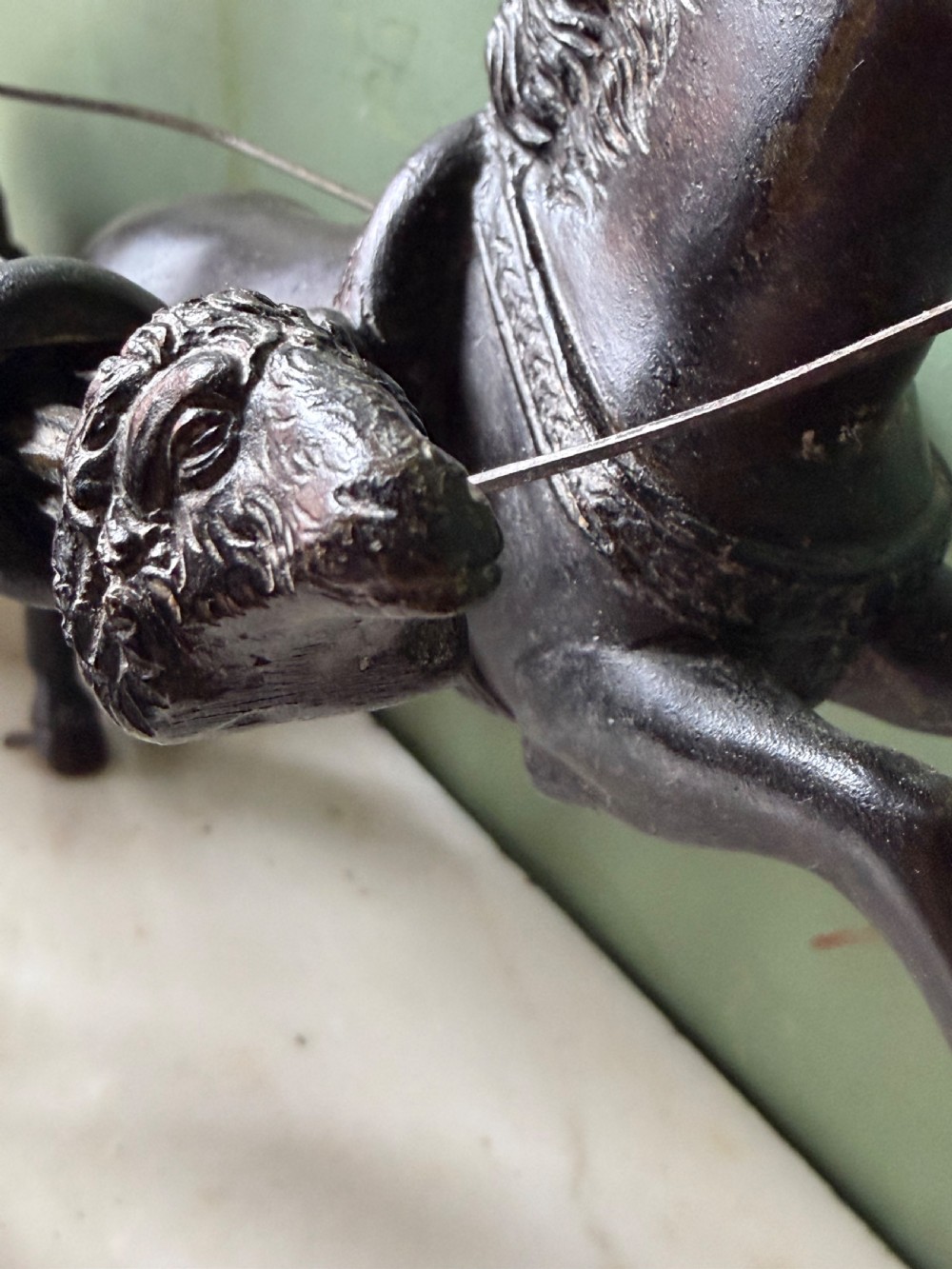 A mid-19th-century dark bronze sculpture depicting a Roman charioteer driving two rearing horses, mounted on a rectangular white marble plinth. View XVIII