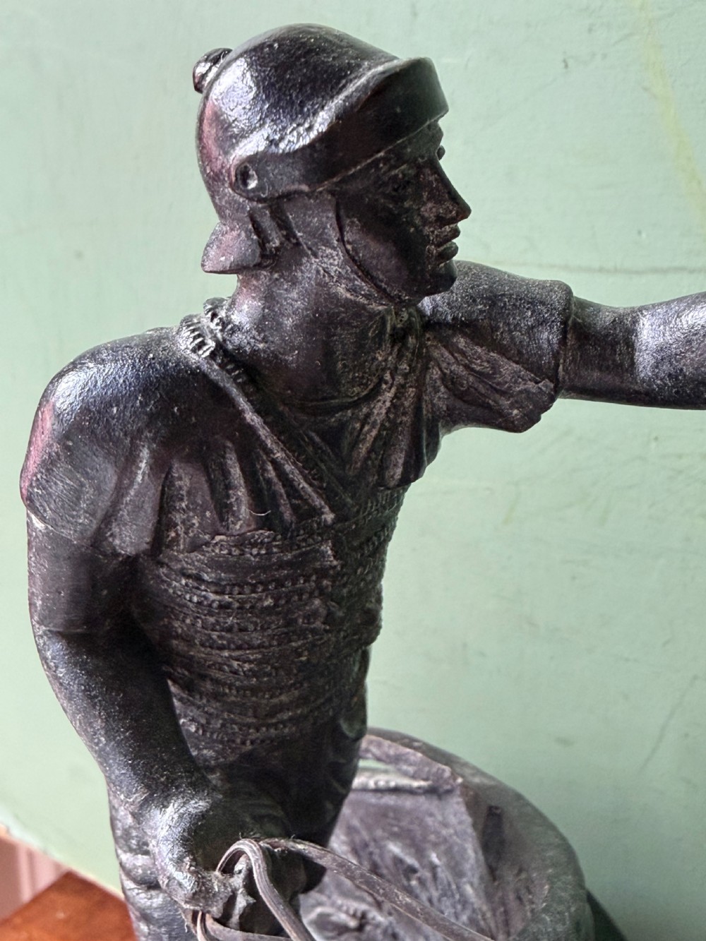 A mid-19th-century dark bronze sculpture depicting a Roman charioteer driving two rearing horses, mounted on a rectangular white marble plinth. View XX