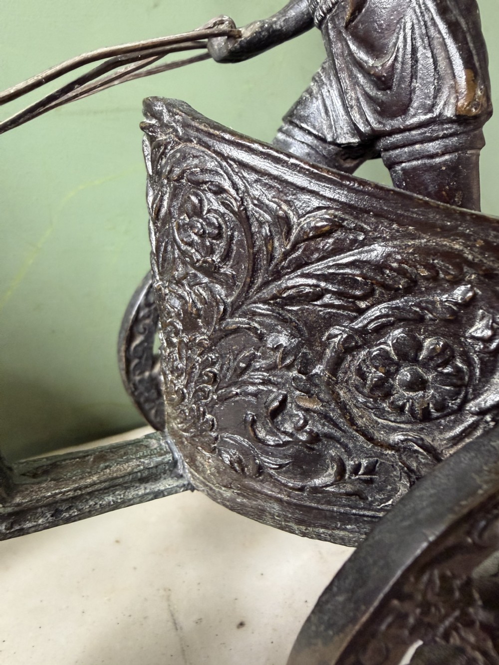 A mid-19th-century dark bronze sculpture depicting a Roman charioteer driving two rearing horses, mounted on a rectangular white marble plinth. View IX