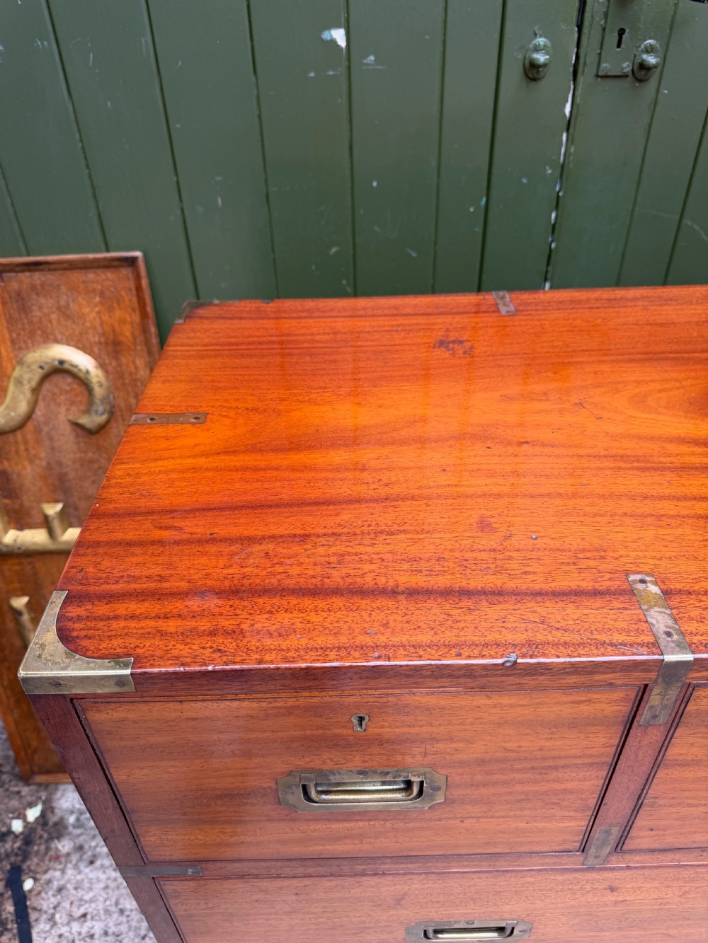 A mid-nineteenth-century mahogany two-part military campaign chest of drawers with flush brass handles, protective brass corners, and turned feet. View IV