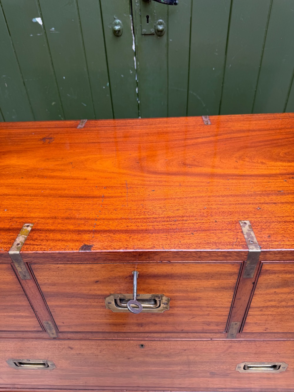 A mid-nineteenth-century mahogany two-part military campaign chest of drawers with flush brass handles, protective brass corners, and turned feet. View VI