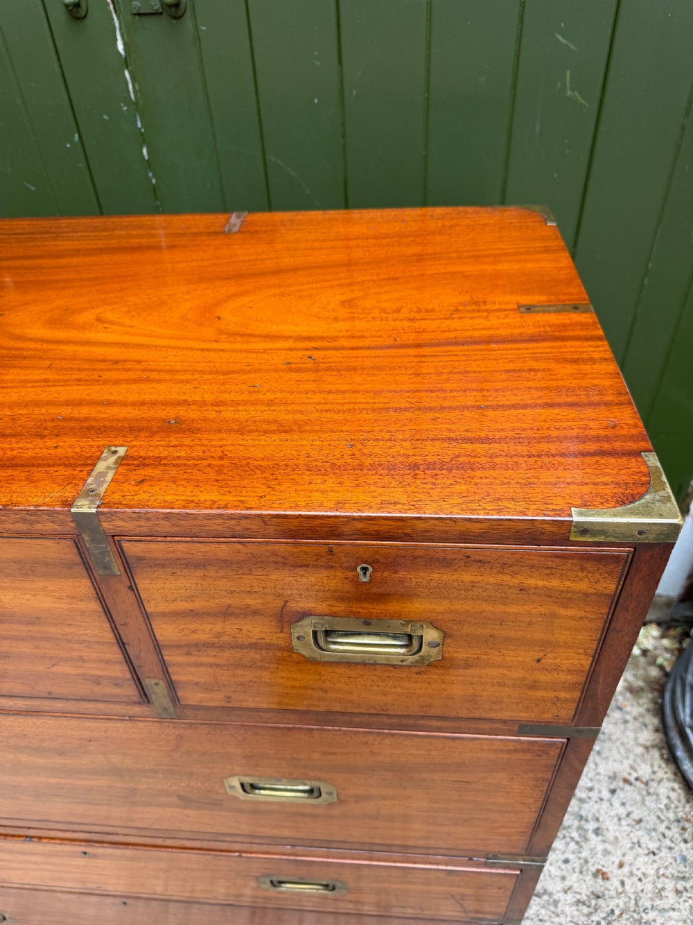 A mid-nineteenth-century mahogany two-part military campaign chest of drawers with flush brass handles, protective brass corners, and turned feet. View VII