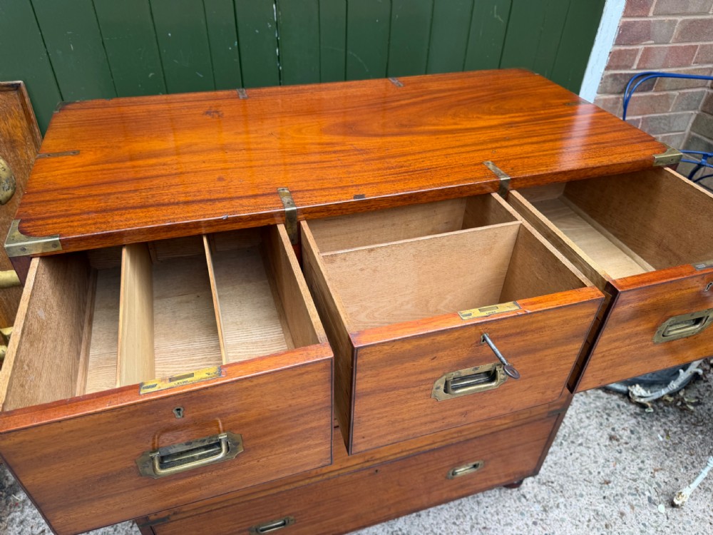 A mid-nineteenth-century mahogany two-part military campaign chest of drawers with flush brass handles, protective brass corners, and turned feet. View VIII