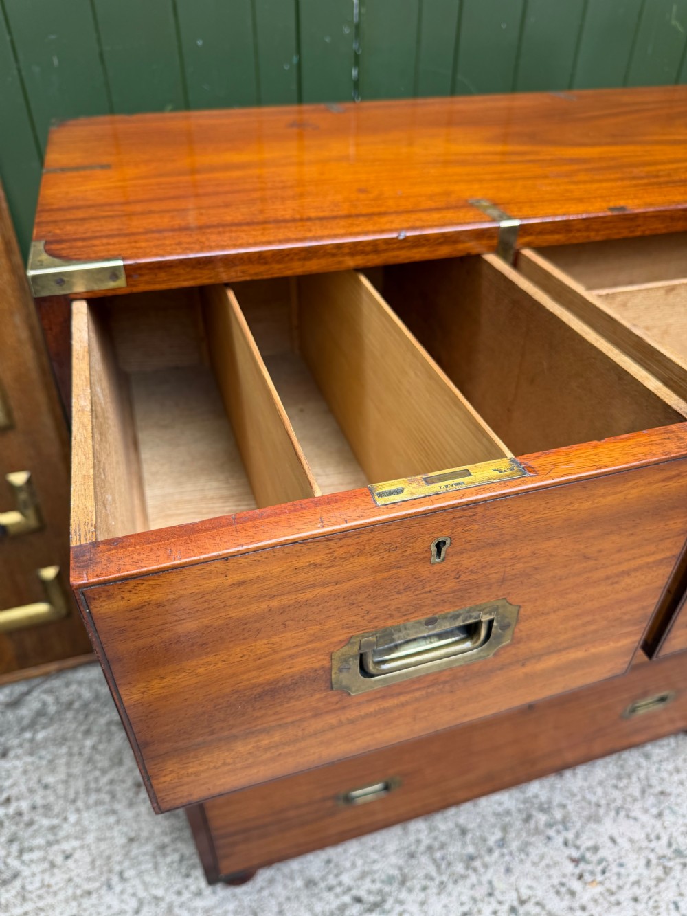 A mid-nineteenth-century mahogany two-part military campaign chest of drawers with flush brass handles, protective brass corners, and turned feet. View IX