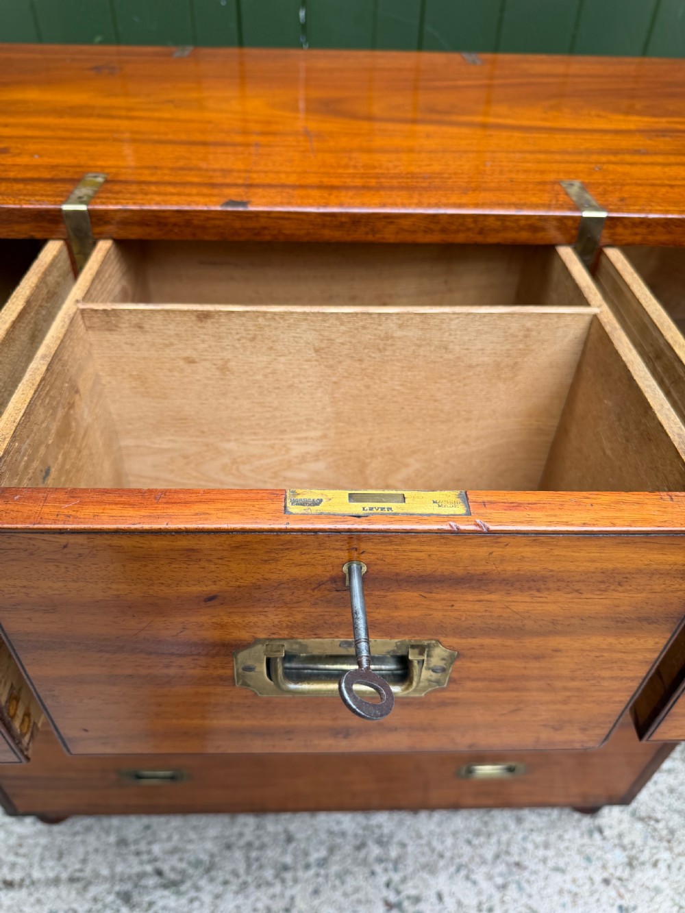 A mid-nineteenth-century mahogany two-part military campaign chest of drawers with flush brass handles, protective brass corners, and turned feet. View X