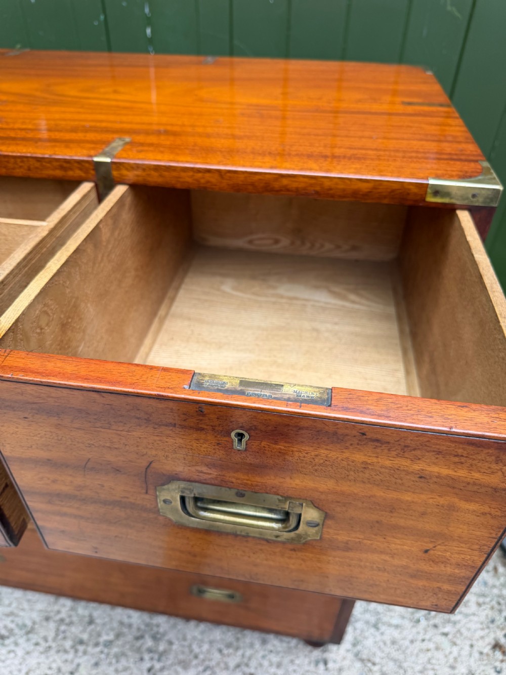 A mid-nineteenth-century mahogany two-part military campaign chest of drawers with flush brass handles, protective brass corners, and turned feet. View XI