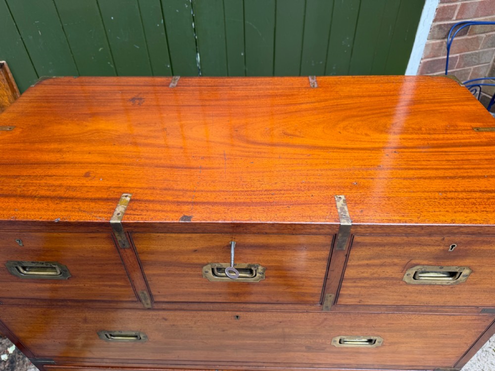 A mid-nineteenth-century mahogany two-part military campaign chest of drawers with flush brass handles, protective brass corners, and turned feet. View XIV