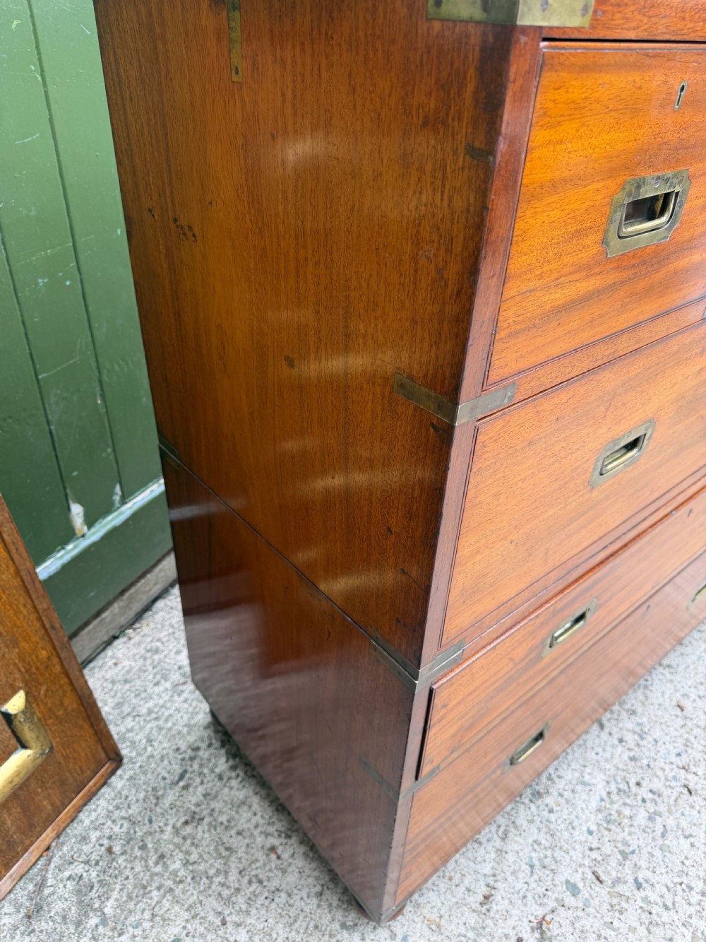 A mid-nineteenth-century mahogany two-part military campaign chest of drawers with flush brass handles, protective brass corners, and turned feet. View XV