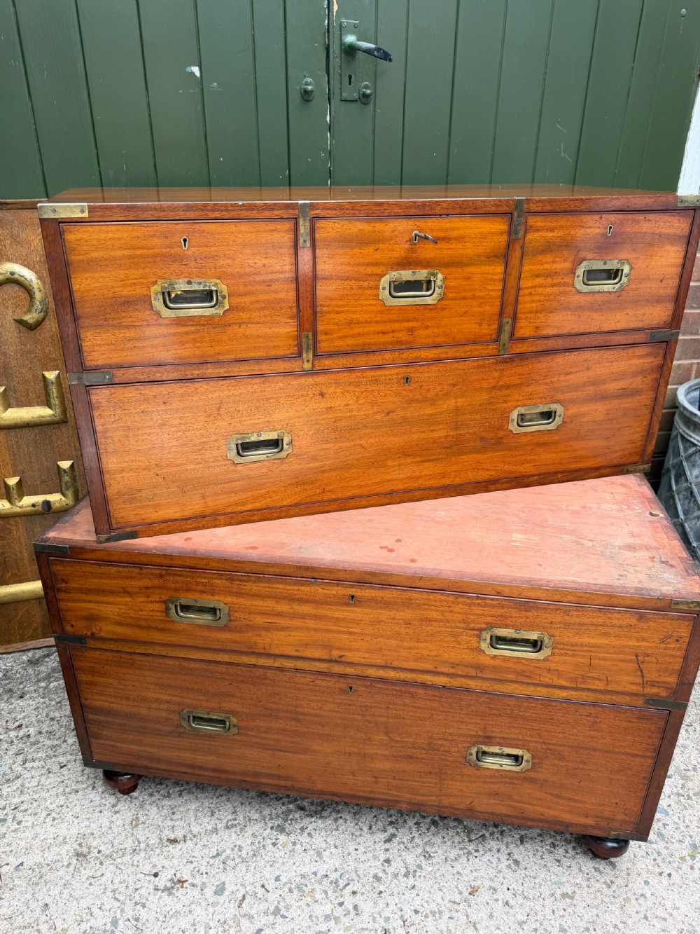 A mid-nineteenth-century mahogany two-part military campaign chest of drawers with flush brass handles, protective brass corners, and turned feet. View XVIII