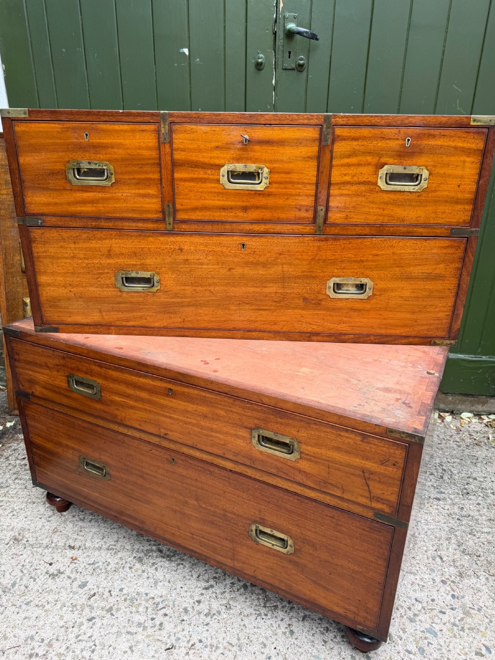 A mid-nineteenth-century mahogany two-part military campaign chest of drawers with flush brass handles, protective brass corners, and turned feet. View XXI