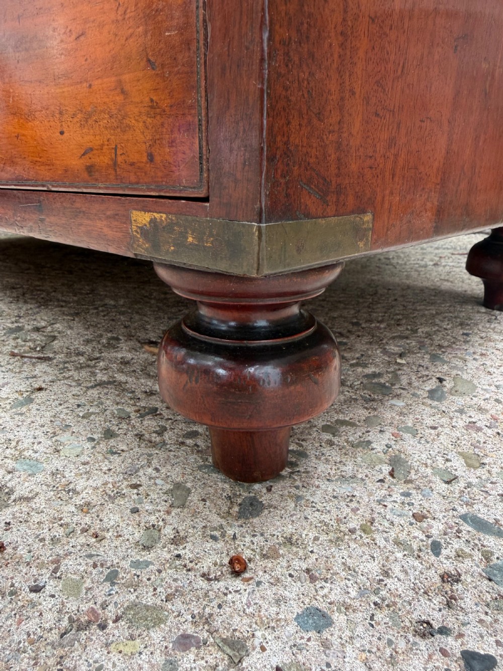 A mid-nineteenth-century mahogany two-part military campaign chest of drawers with flush brass handles, protective brass corners, and turned feet. View XXII
