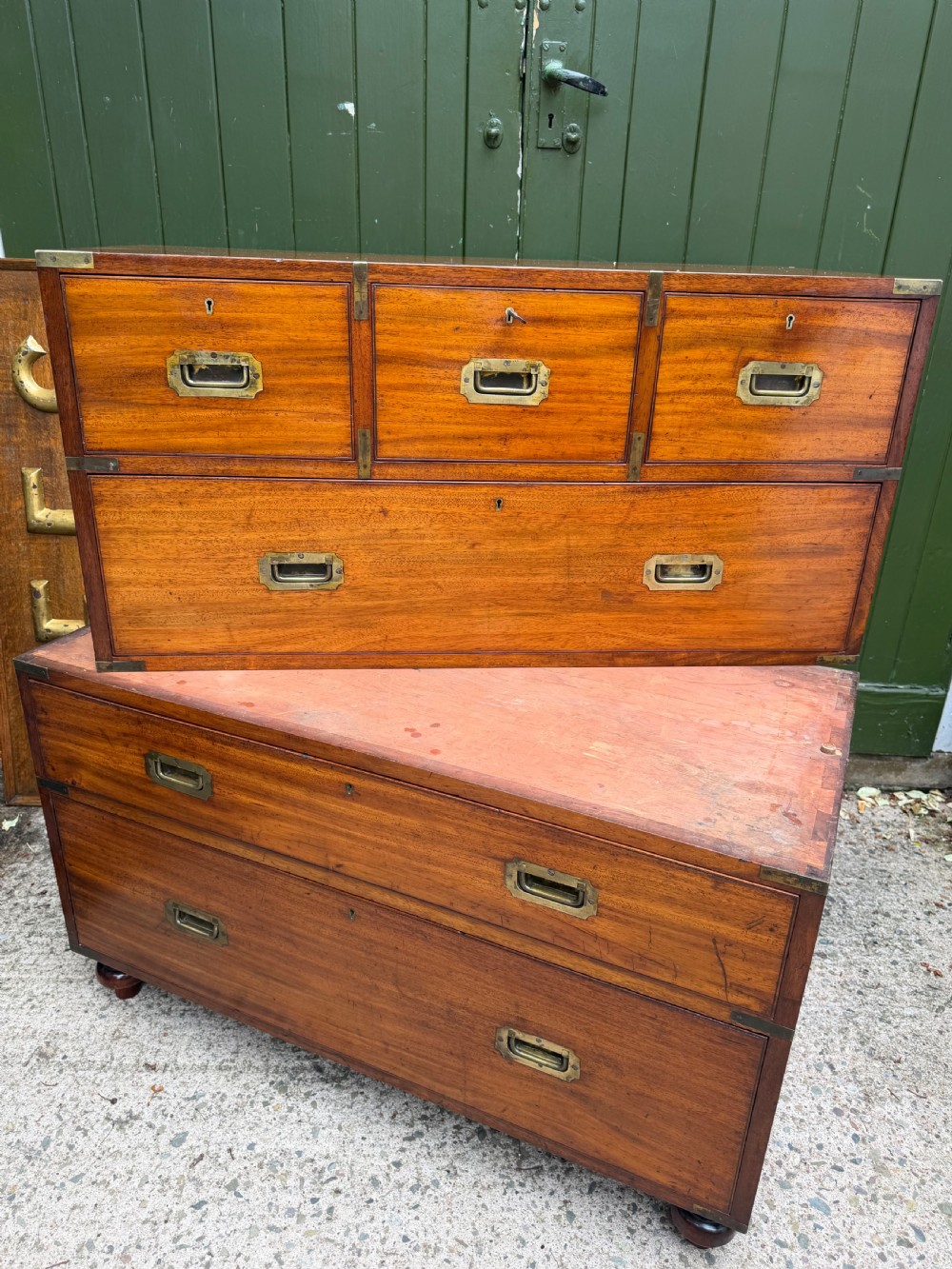 A mid-nineteenth-century mahogany two-part military campaign chest of drawers with flush brass handles, protective brass corners, and turned feet. View XXIII