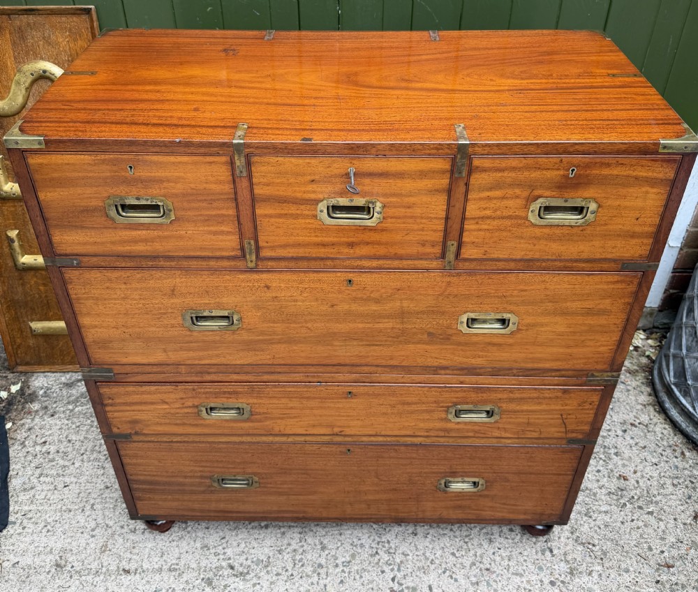 A mid-nineteenth-century mahogany two-part military campaign chest of drawers with flush brass handles, protective brass corners, and turned feet. View II
