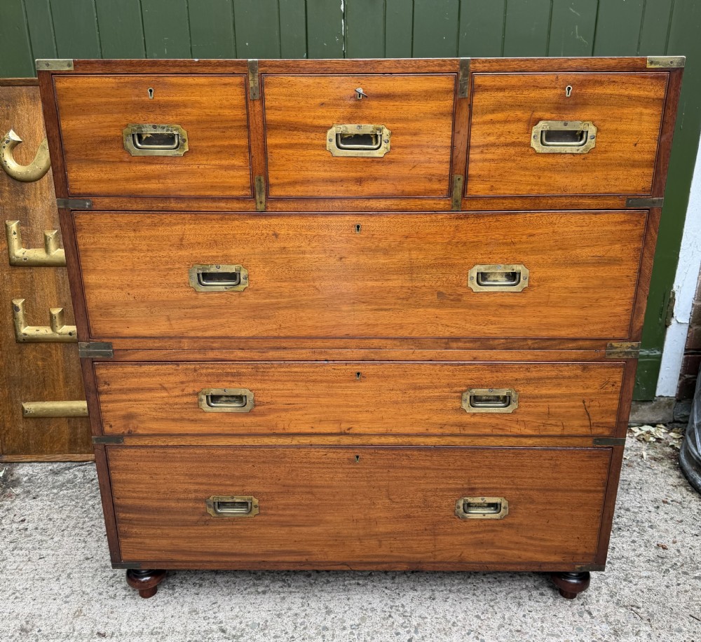 A mid-nineteenth-century mahogany two-part military campaign chest of drawers with flush brass handles, protective brass corners, and turned feet. View III