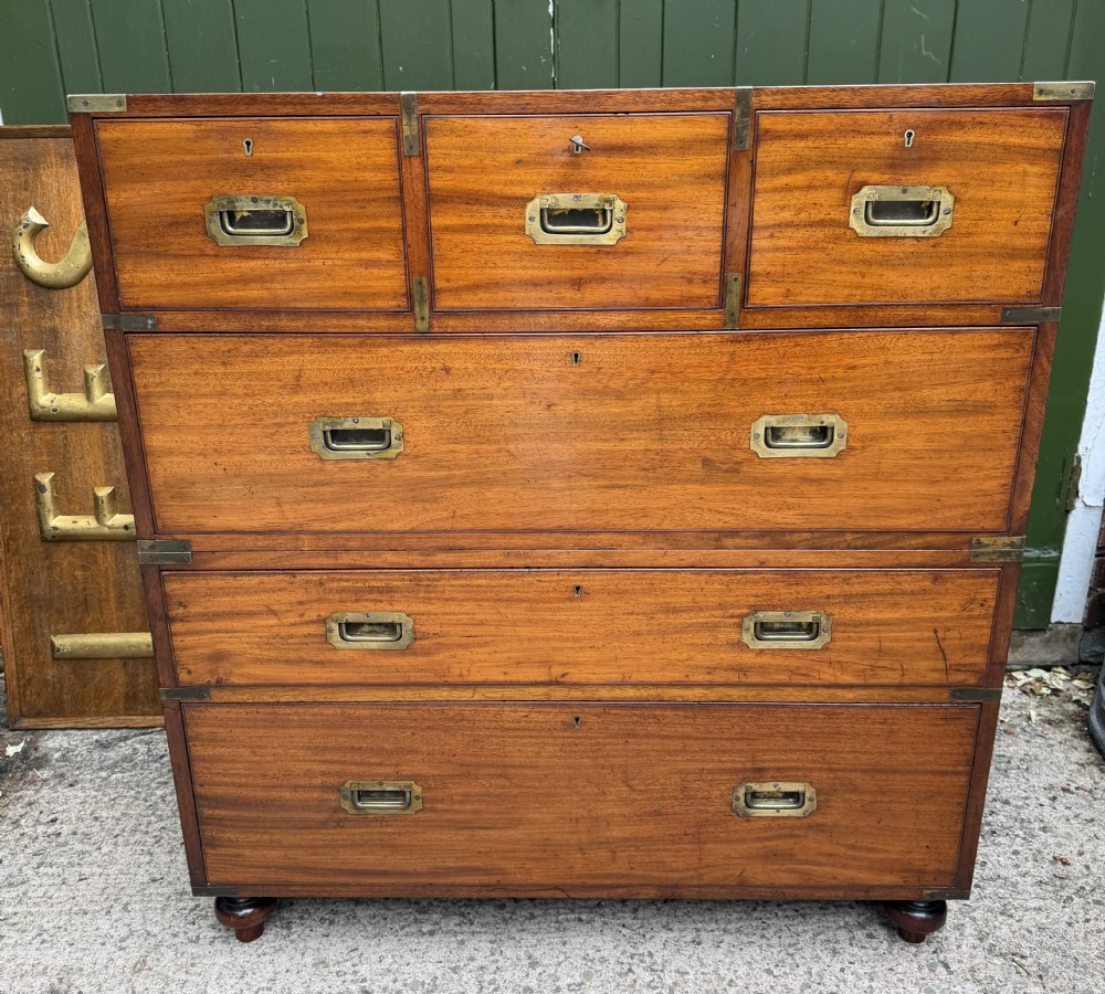 A mid-nineteenth-century mahogany two-part military campaign chest of drawers with flush brass handles, protective brass corners, and turned feet. View XII