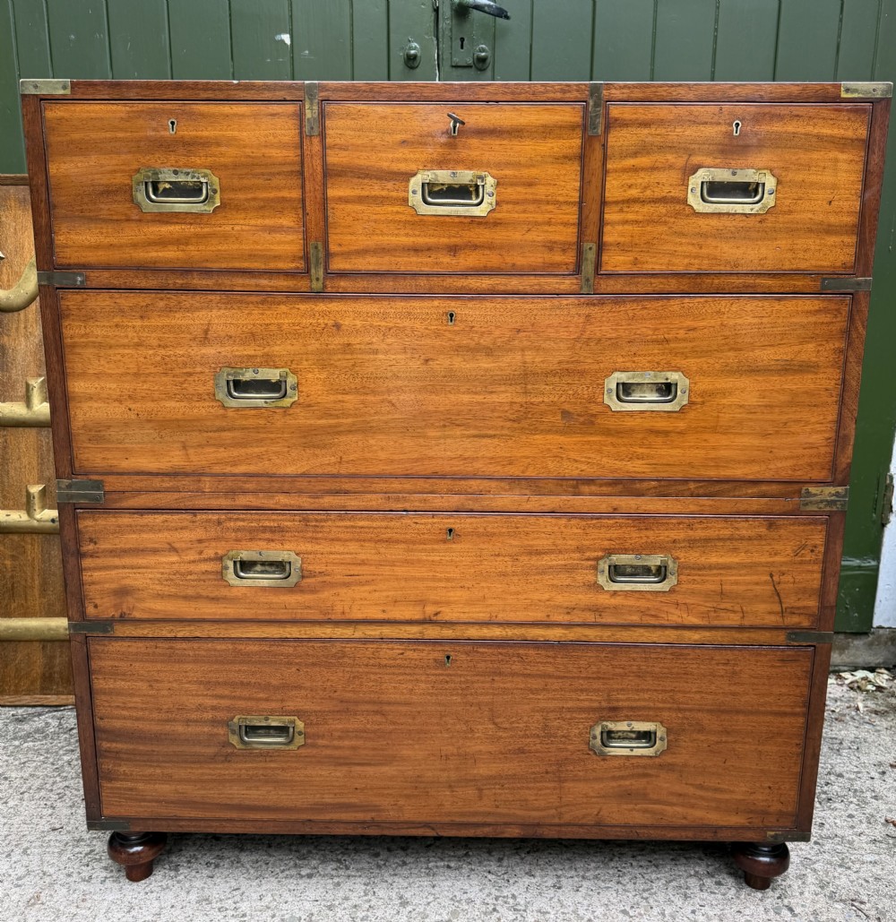 A mid-nineteenth-century mahogany two-part military campaign chest of drawers with flush brass handles, protective brass corners, and turned feet. View XXV