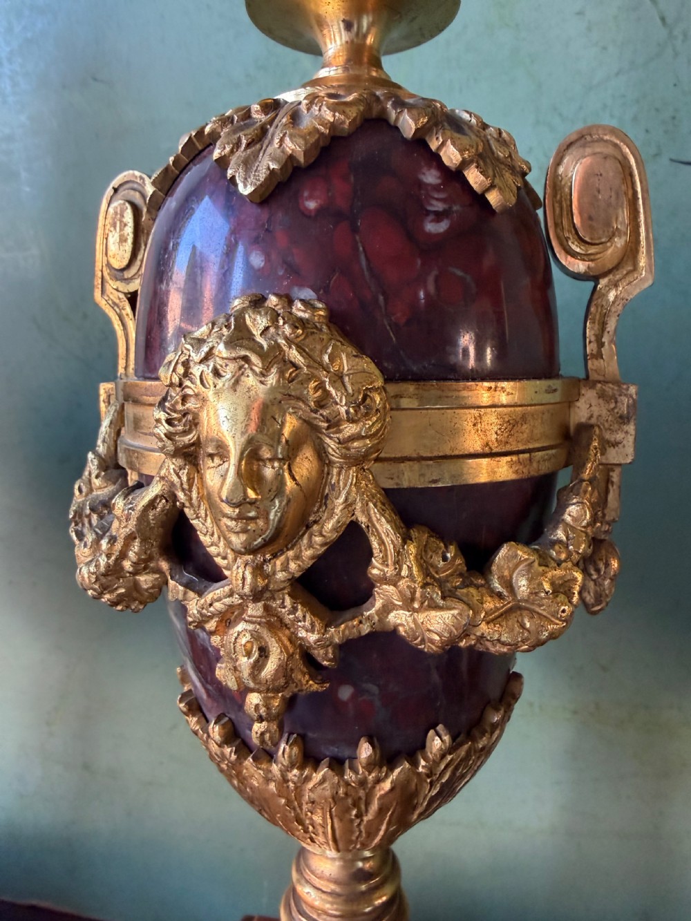 A pair of late nineteenth-century French rouge marble table lamps shaped as urns with gilt bronze mounts and square pedestal bases. View VII