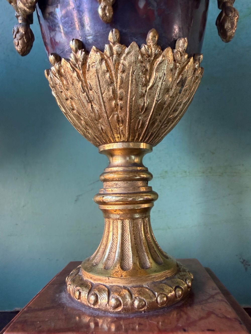 A pair of late nineteenth-century French rouge marble table lamps shaped as urns with gilt bronze mounts and square pedestal bases. View IX