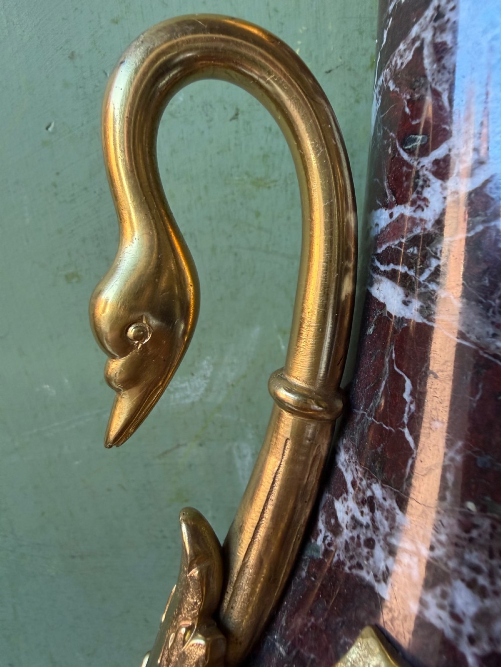 A pair of urn-shaped burgundy marble table lamps featuring gilded bronze swan handles and square pedestals. View VI