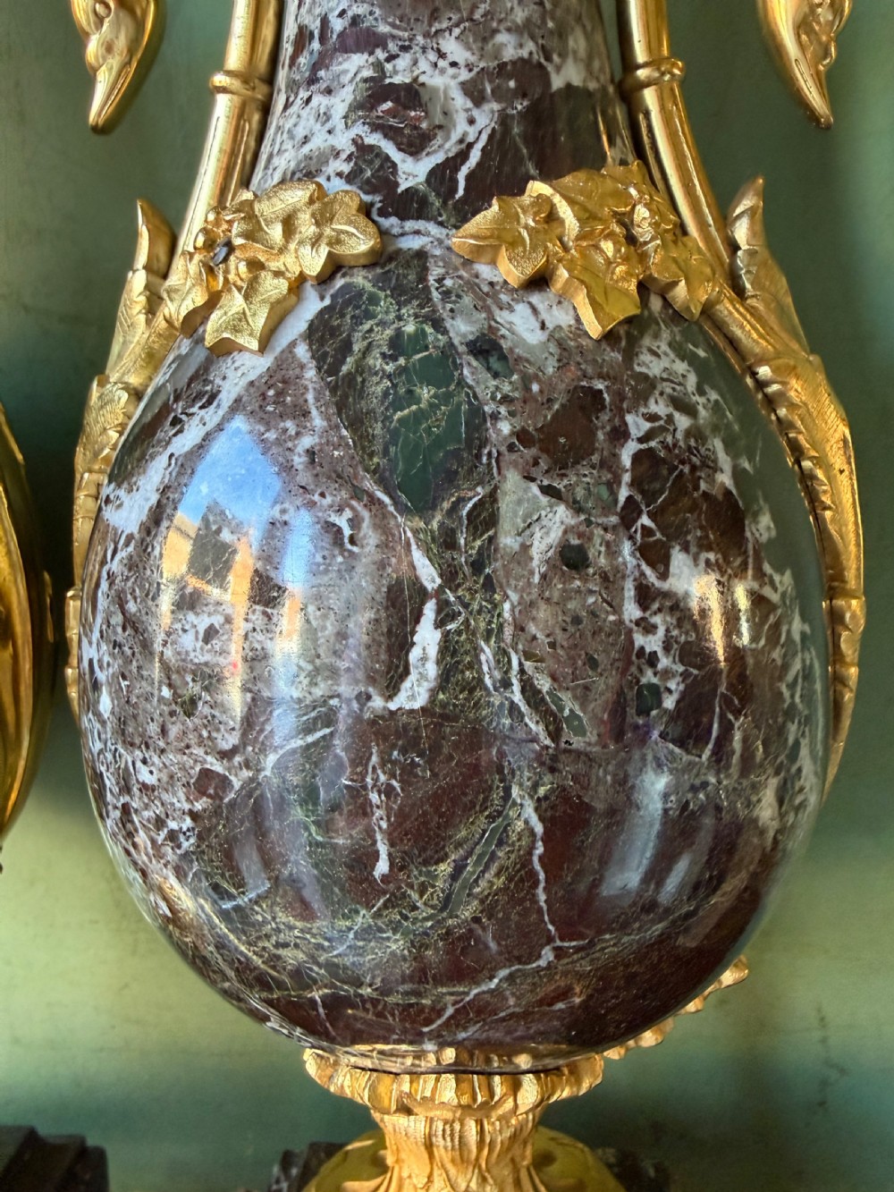 A pair of urn-shaped burgundy marble table lamps featuring gilded bronze swan handles and square pedestals. View IX