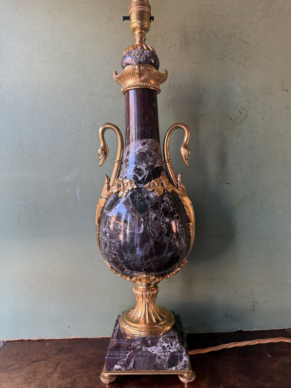A pair of urn-shaped burgundy marble table lamps featuring gilded bronze swan handles and square pedestals. View XII