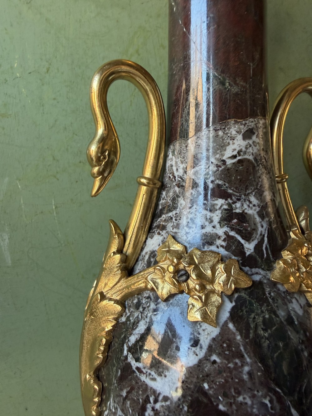 A pair of urn-shaped burgundy marble table lamps featuring gilded bronze swan handles and square pedestals. View XIII
