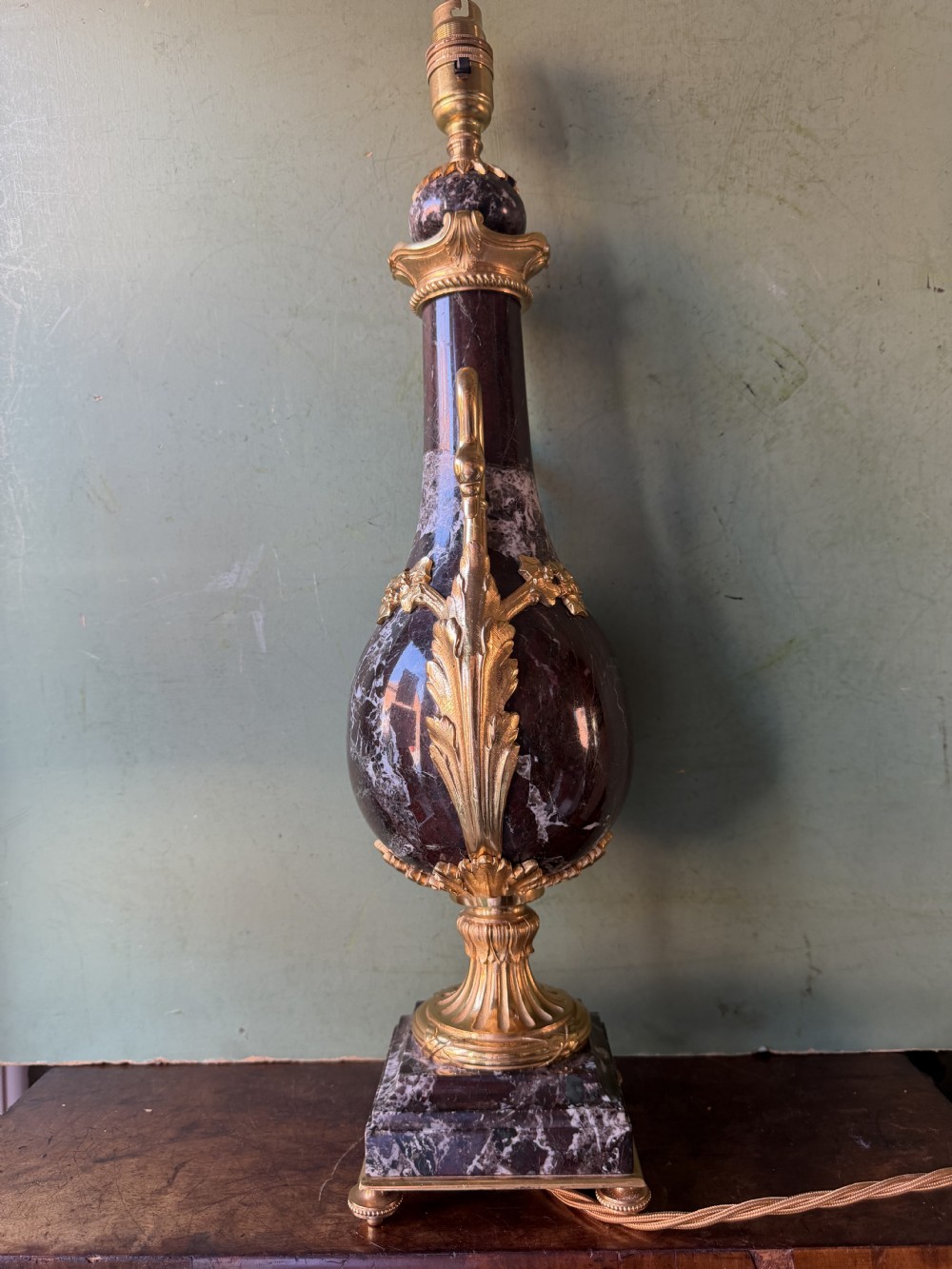 A pair of urn-shaped burgundy marble table lamps featuring gilded bronze swan handles and square pedestals. View XVI