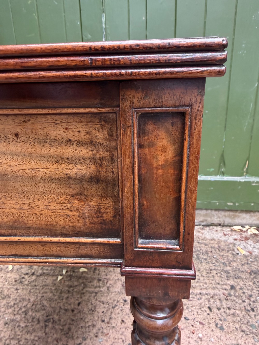 Early 19th-century George IV mahogany writing table featuring a long frieze drawer with brass rosette handles and reeded turned legs on castors. View IX