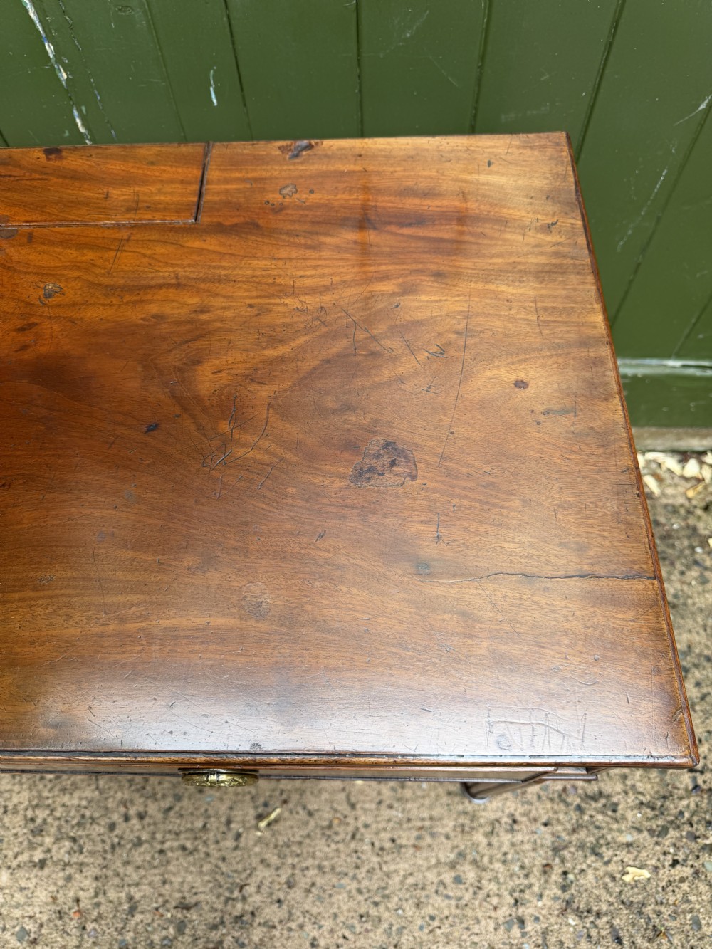 Early 19th-century George IV mahogany writing table featuring a long frieze drawer with brass rosette handles and reeded turned legs on castors. View XXIV