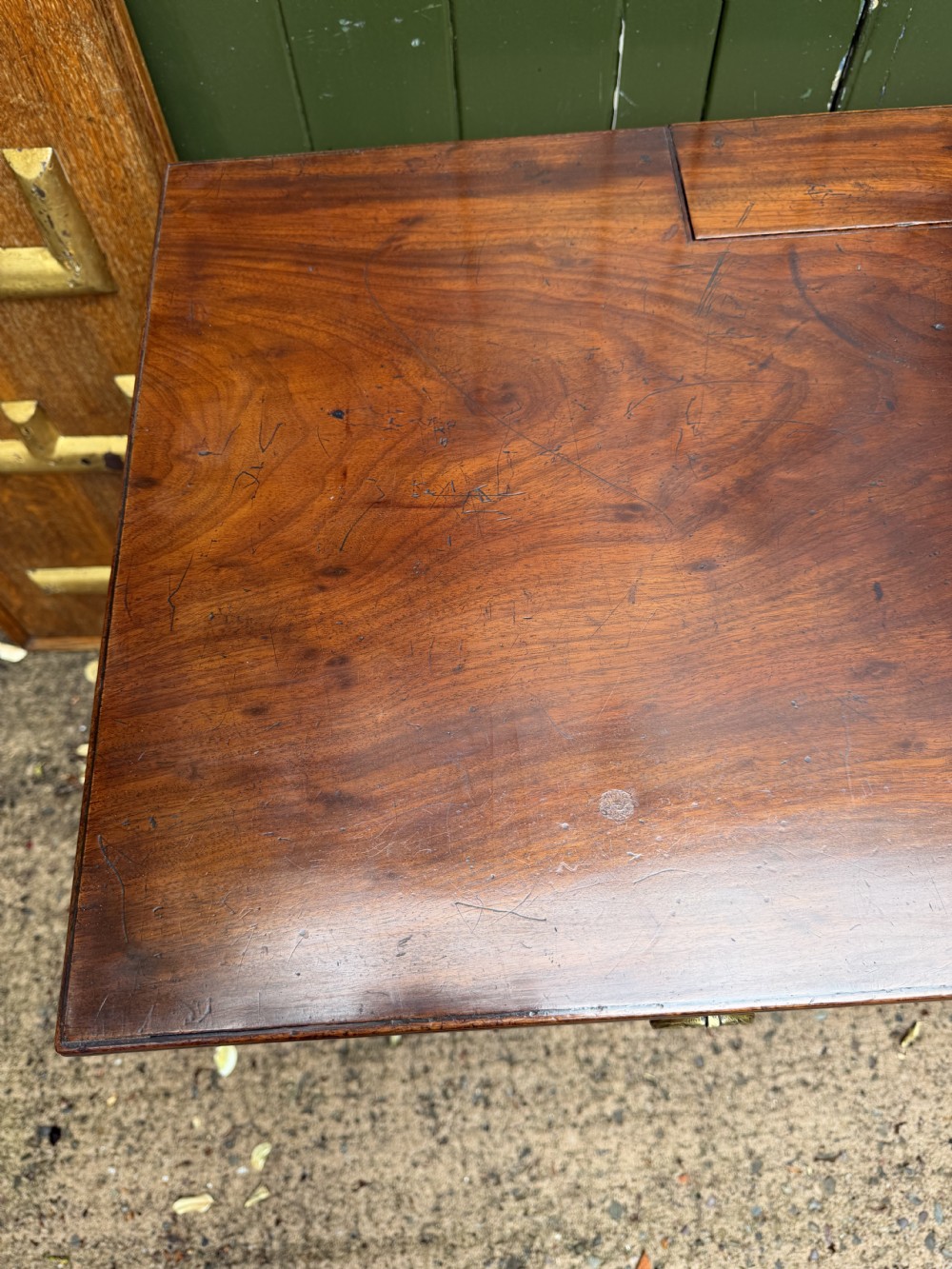Early 19th-century George IV mahogany writing table featuring a long frieze drawer with brass rosette handles and reeded turned legs on castors. View XXIII