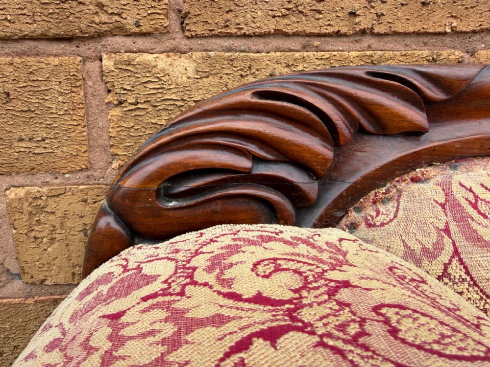 Early 19th-century William IV carved mahogany scroll-end sofa upholstered in red and gold patterned damask with matching bolster cushions. View VI