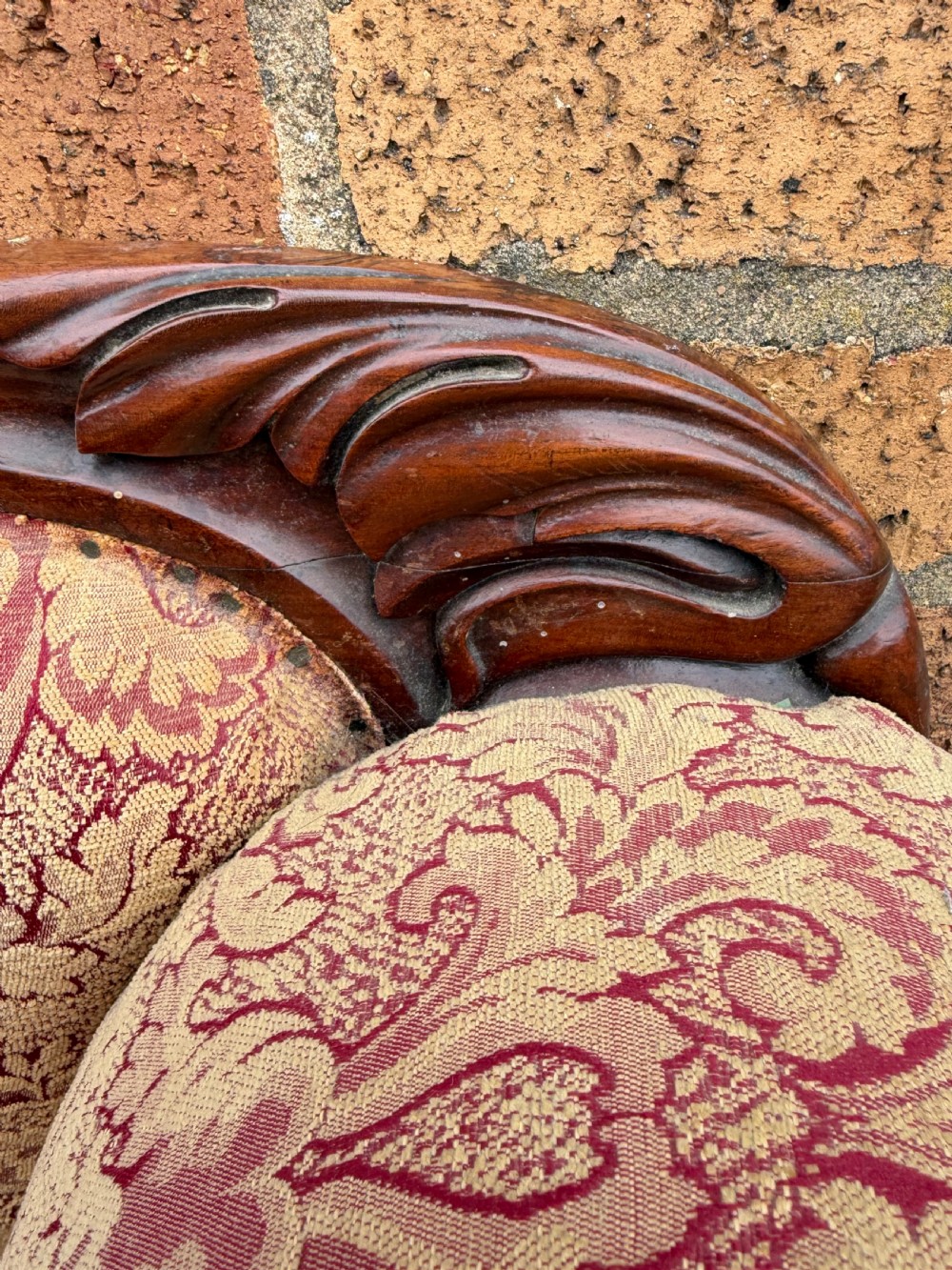 Early 19th-century William IV carved mahogany scroll-end sofa upholstered in red and gold patterned damask with matching bolster cushions. View IX