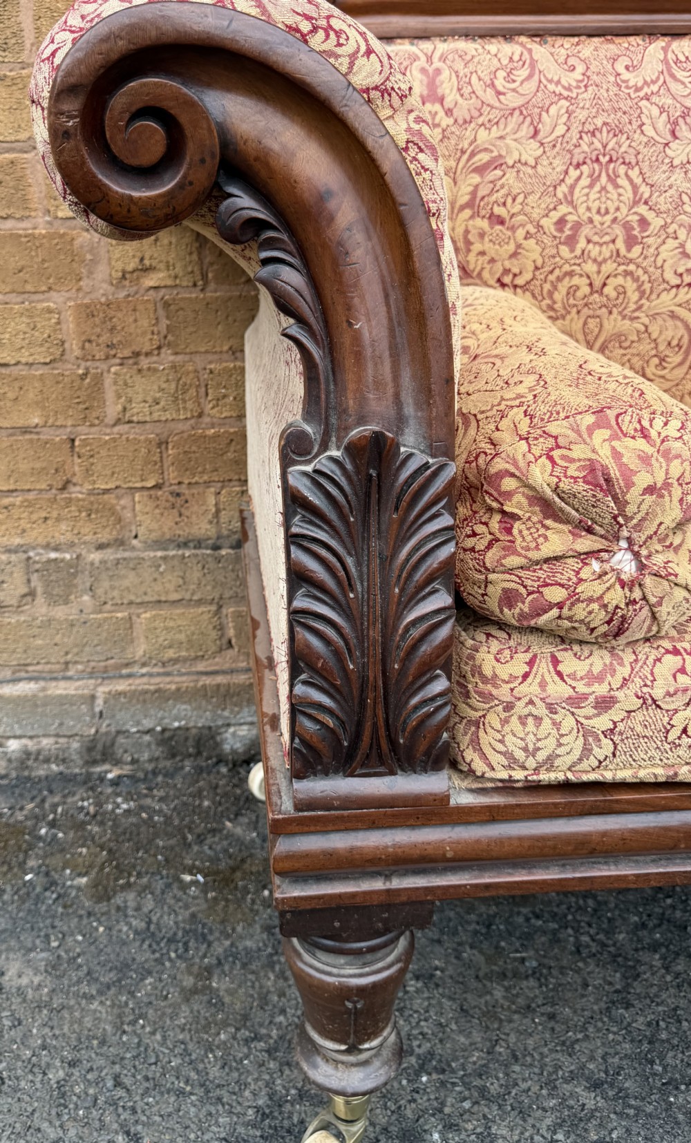 Early 19th-century William IV carved mahogany scroll-end sofa upholstered in red and gold patterned damask with matching bolster cushions. View II