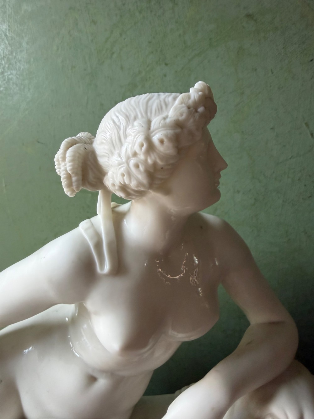 A white Parian porcelain Neoclassical sculpture depicting a reclining female figure mounted on the back of a panther on a rectangular plinth. View V