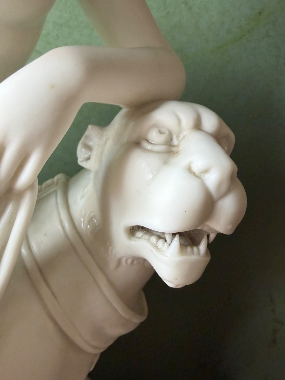 A white Parian porcelain Neoclassical sculpture depicting a reclining female figure mounted on the back of a panther on a rectangular plinth. View VI