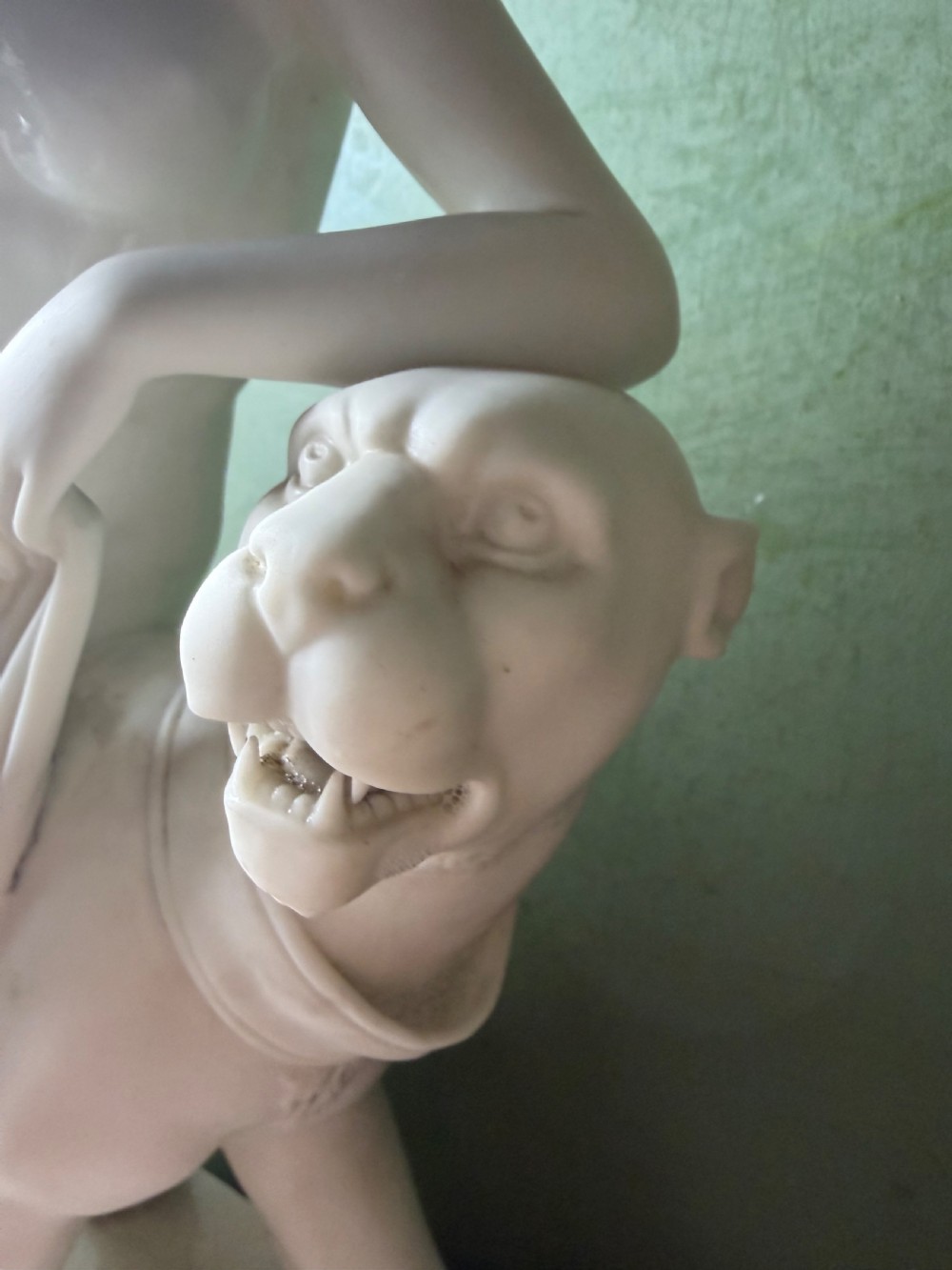 A white Parian porcelain Neoclassical sculpture depicting a reclining female figure mounted on the back of a panther on a rectangular plinth. View XII