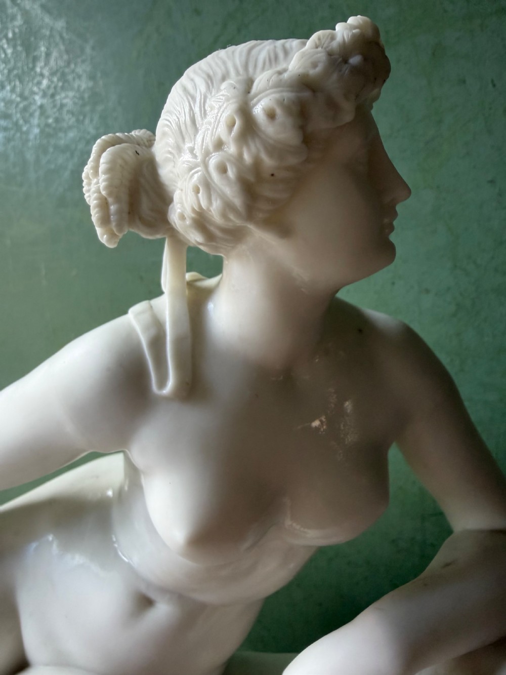 A white Parian porcelain Neoclassical sculpture depicting a reclining female figure mounted on the back of a panther on a rectangular plinth. View XIV