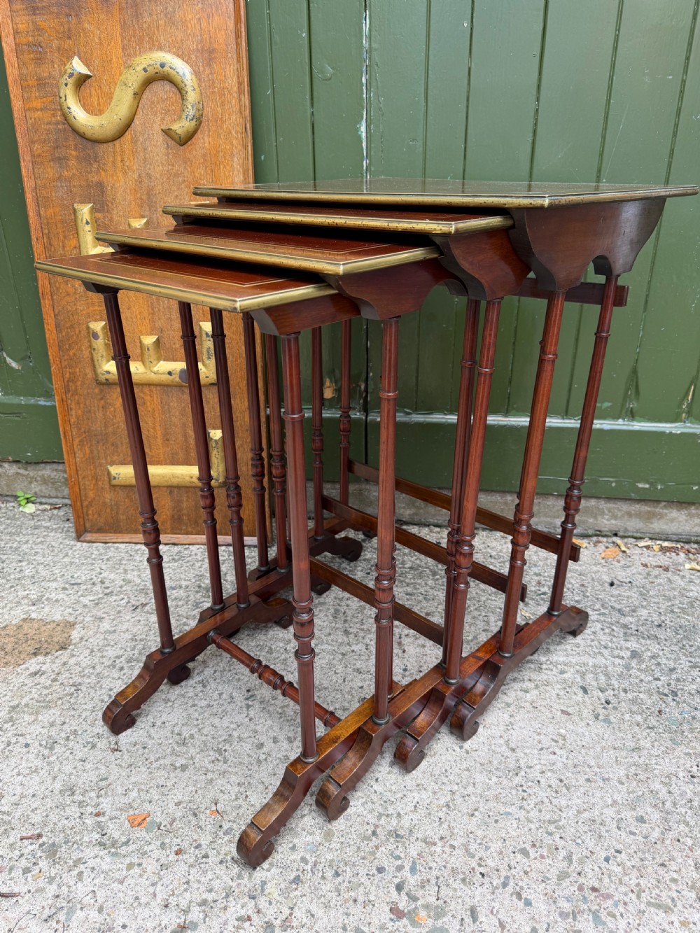 An early nineteenth-century Regency quartetto set of four rosewood nesting tables with brass line inlay and slender turned legs. View V