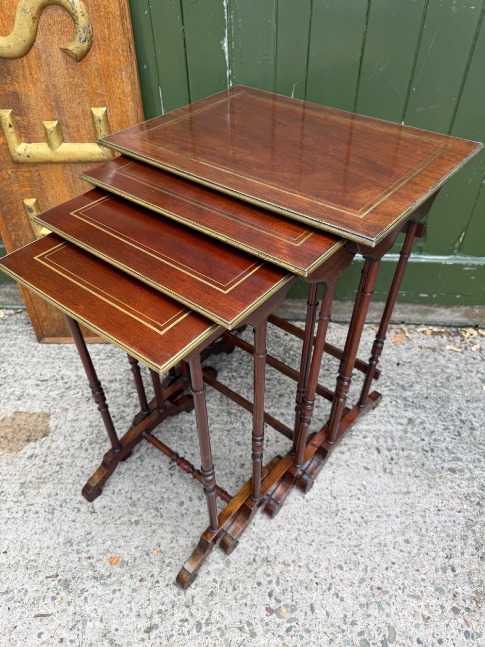 An early nineteenth-century Regency quartetto set of four rosewood nesting tables with brass line inlay and slender turned legs. View VI